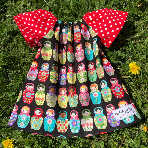 Sewfunky Pixie Dress - Nesting Dolls on Black with Polka Dot Sleeves